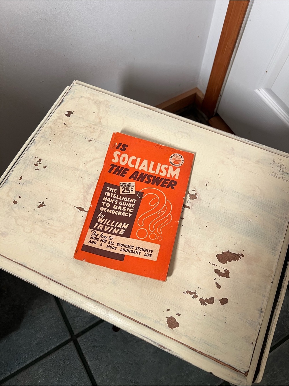 Orange Paperback Book — "Is Socialism the Answer"